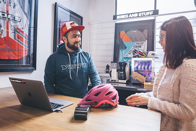 Lady paying for cycle helmet instore