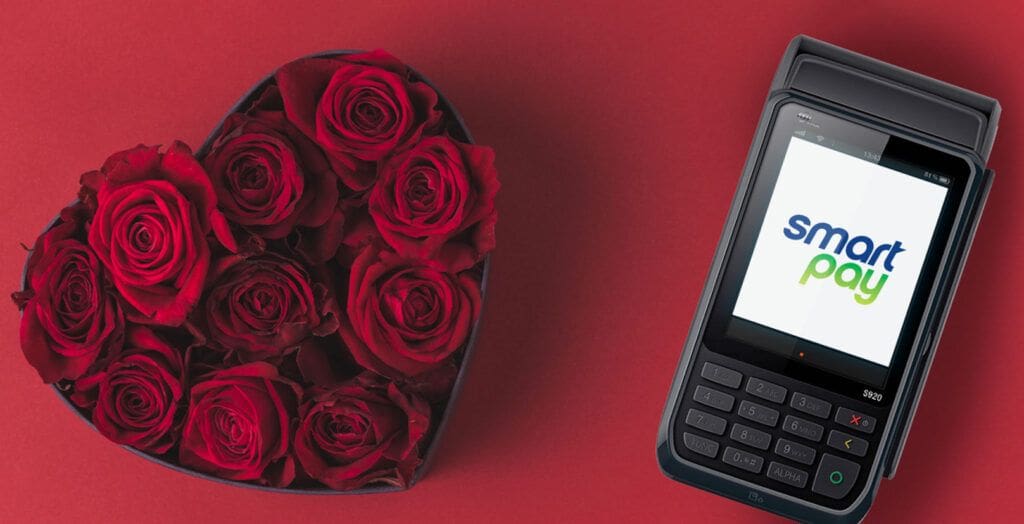 EFTPOS machine next to a heart shaped bouquet of roses