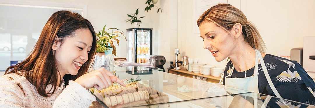 Lady choosing patisserie instore