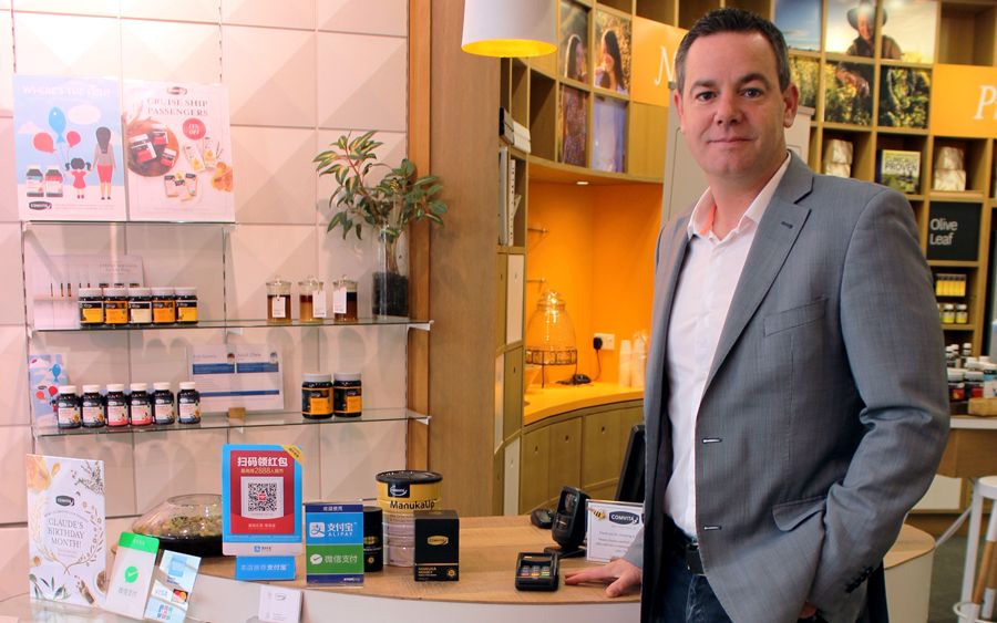 Man dressed in suit in front of retail counter