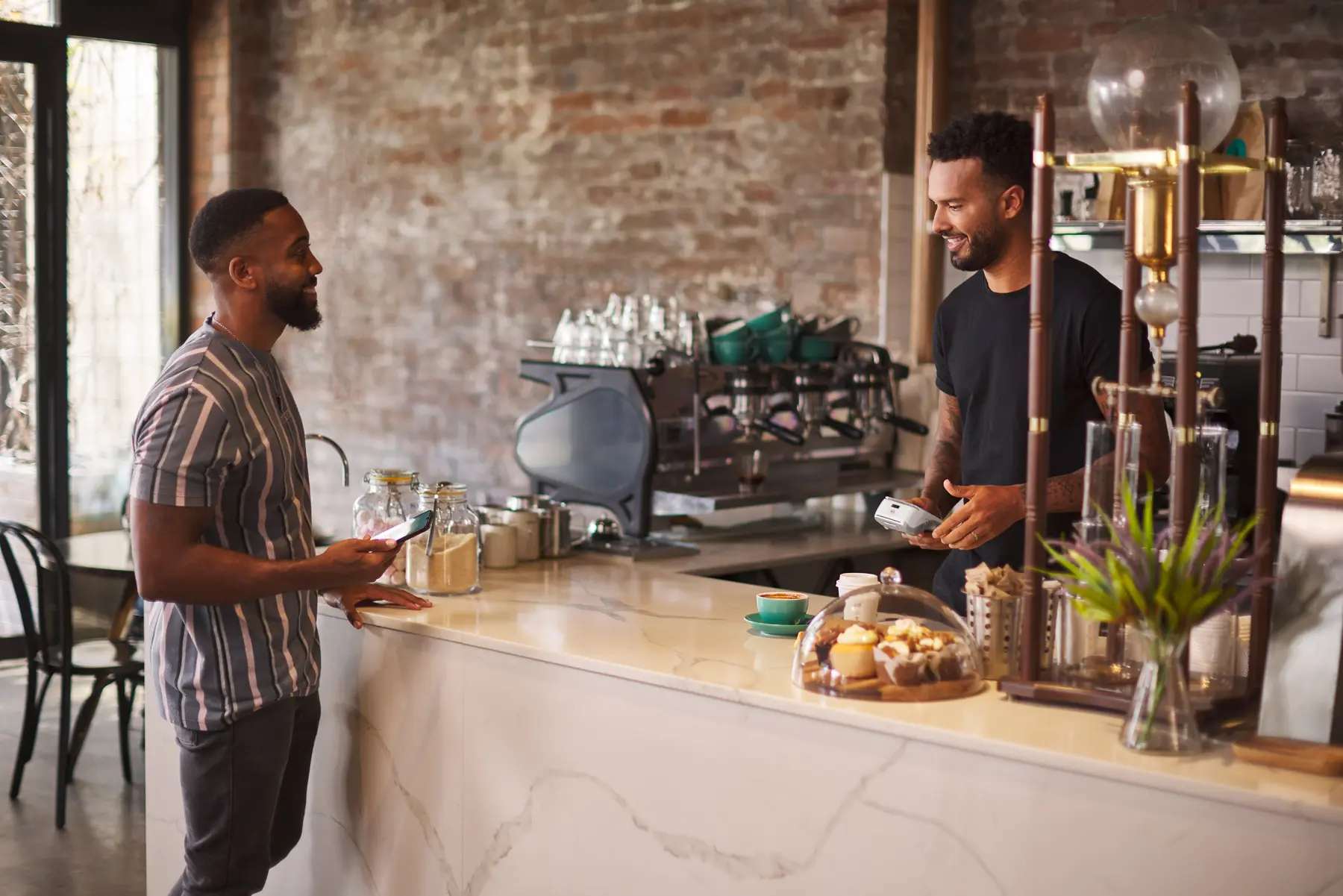 Customer preparing to pay coffee merchant in Cafe