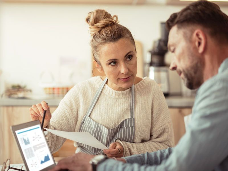 Business owners discussing numbers on a screen