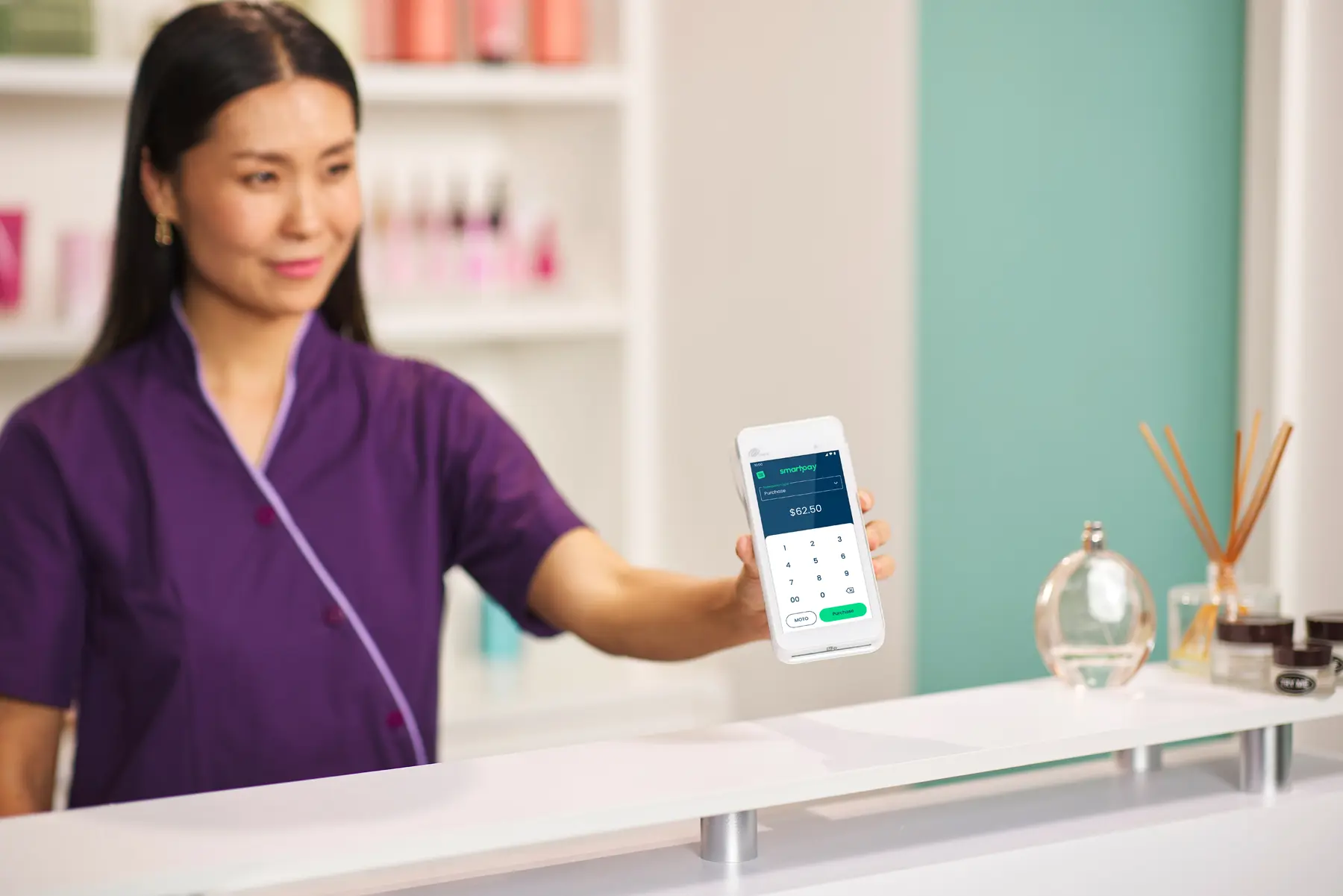 Beauty salon merchant holding out Smartpay A920Pro purchase ready