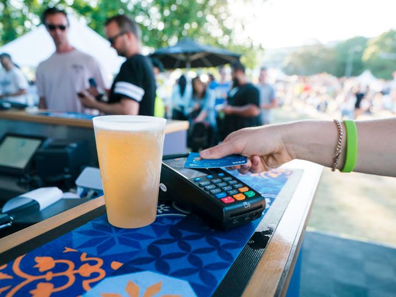 contactless card payment on EFTPOS machine with beer on the side