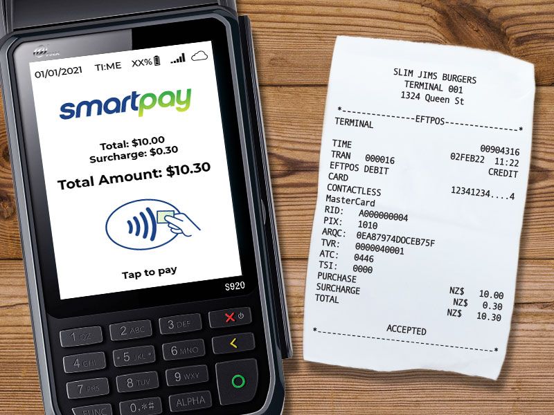 EFTPOS machine with surcharge screen and surcharge receipt beside it