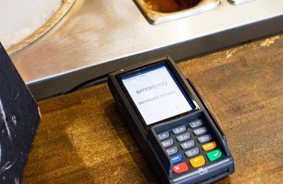 Smartpay terminal lying on ice cream shop counter