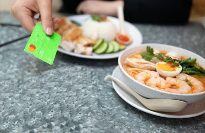Customer handing over card to pay for soup bowls