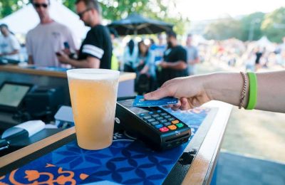 contactless card payment on EFTPOS machine with beer on the side