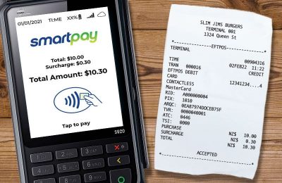 EFTPOS machine with surcharge screen and surcharge receipt beside it